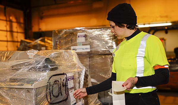 Auk Tozier puts a label on a pallet of recyclables.