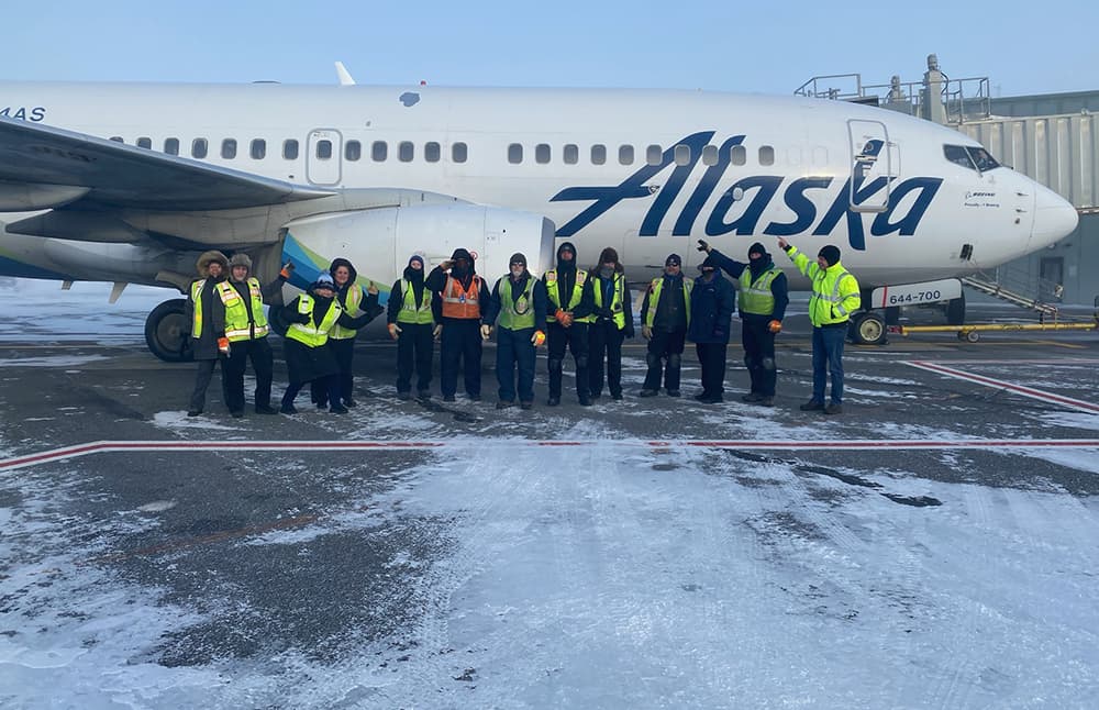 Alaska Airlines team in front of plane, Prudhoe Bay, Alaska
