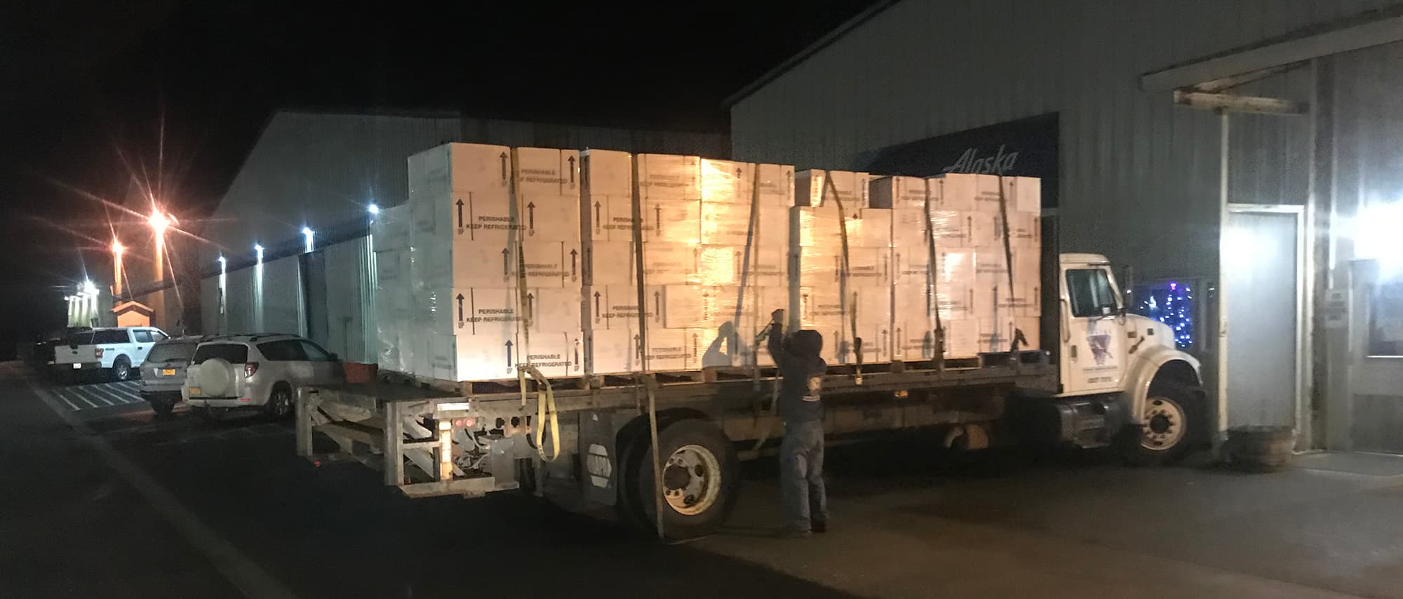Night scene with truck loaded with pallets of geoducks