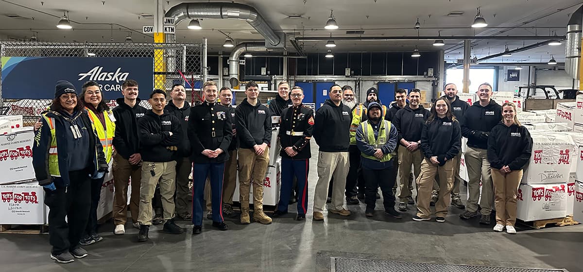 Toys for Tots team lined up in Alaska Air Cargo warehouse, Anchorage.